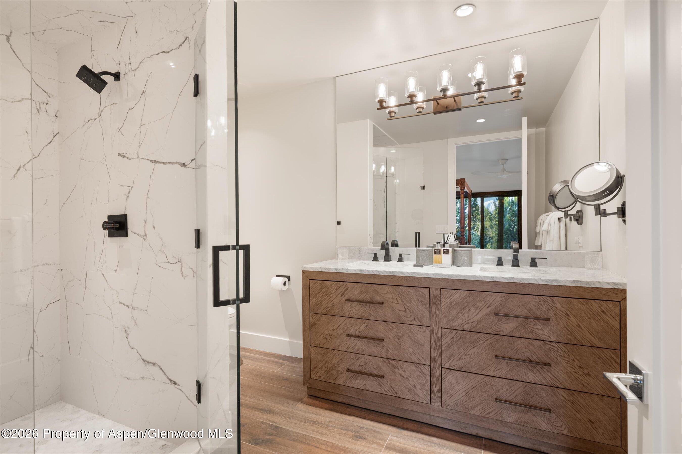 258 Monarch Road Glenwood Springs, CO 81601 - Photo 51 of 73 a bathroom with a double vanity sink mirror and shower