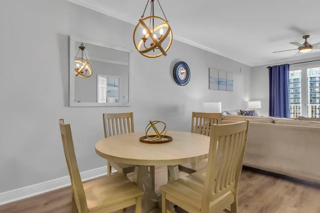 a kitchen with refrigerator and chairs