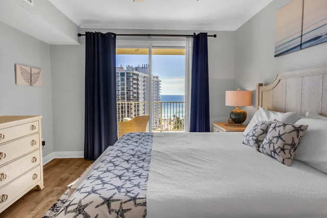 a bedroom with a large bed and a window