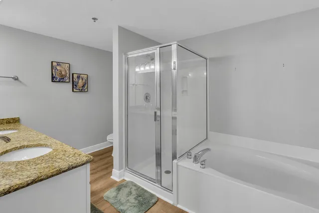 a bedroom with a bed and a flat tv screen on dresser