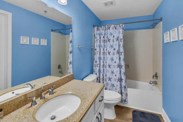 a bedroom with a bed and a flat tv screen