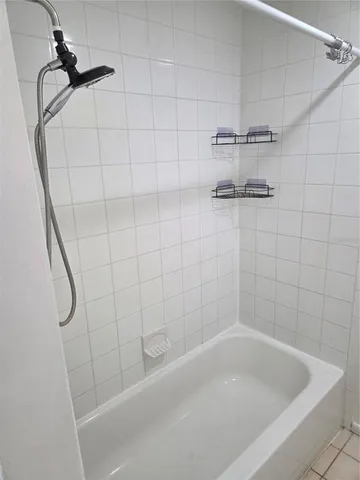 a bath tub sitting next to a shower
