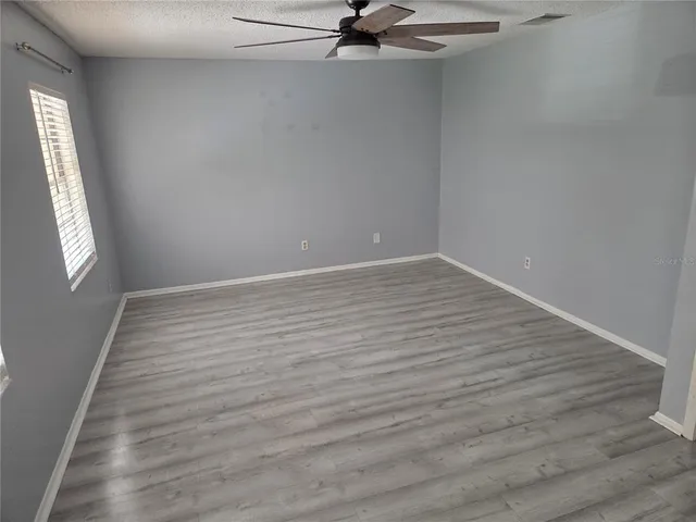 a view of a room with wooden floor and window
