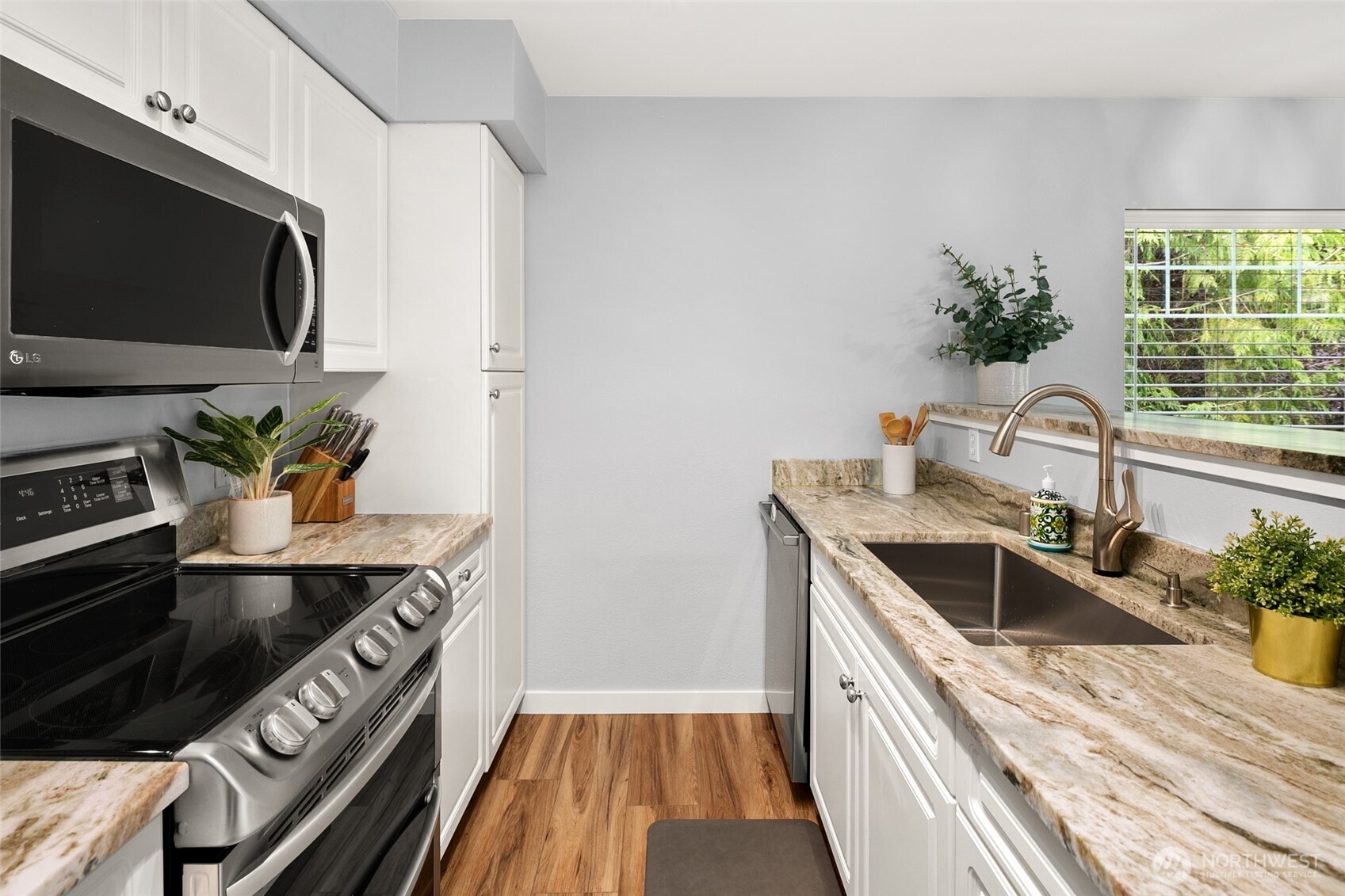 15150 140th Way Southeast, Unit M201 Renton, WA 98058 - Photo 8 of 27 a kitchen with sink stove and microwave