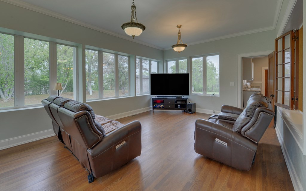 2465 Blue Ridge Drive Blue Ridge, GA 30513 - Photo 22 of 60 a living room with furniture a ceiling fan and a flat screen tv