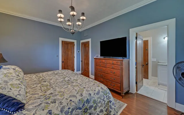 an empty room with closet and windows