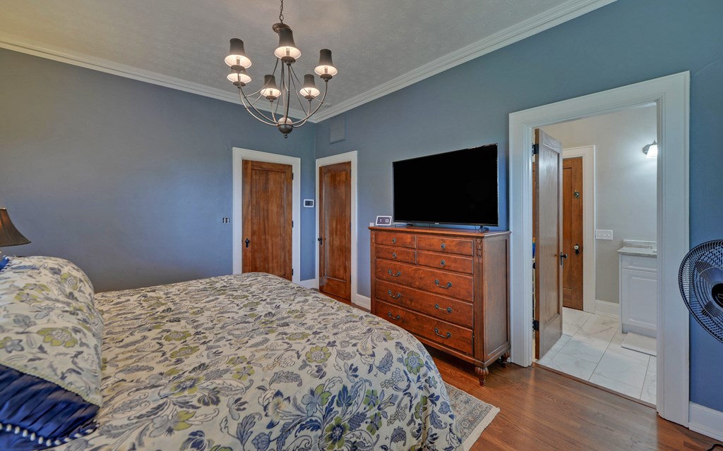 2465 Blue Ridge Drive Blue Ridge, GA 30513 - Photo 32 of 60 a bedroom with a bed and a flat tv screen on dresser