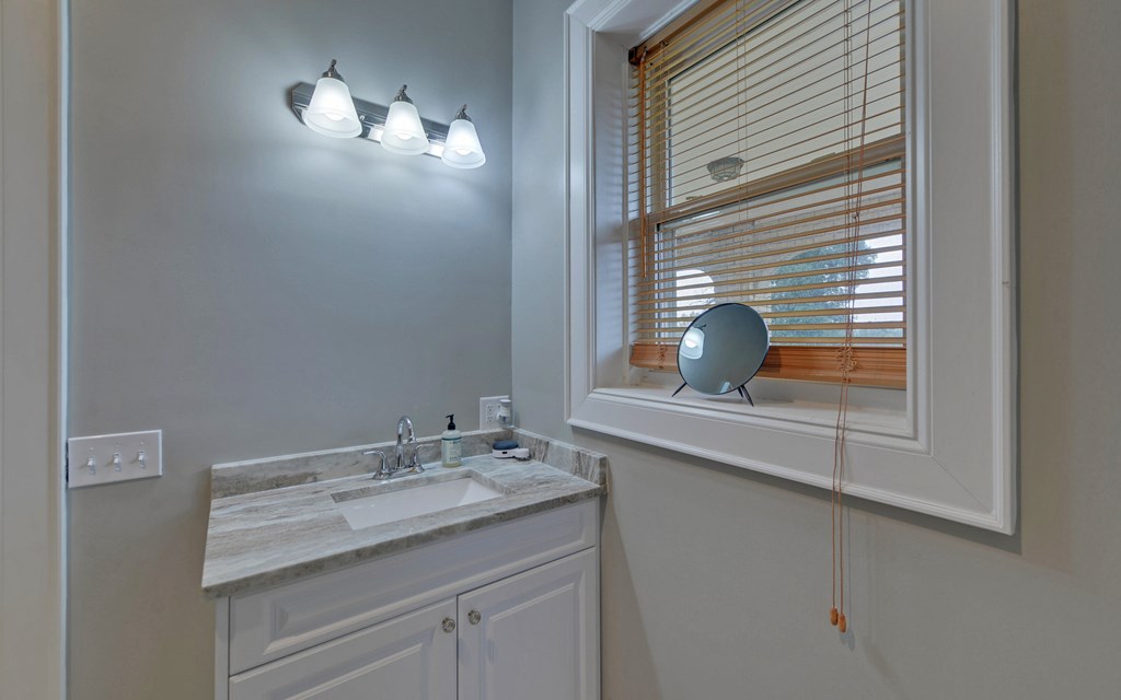 2465 Blue Ridge Drive Blue Ridge, GA 30513 - Photo 33 of 60 a bathroom with a sink and a mirror