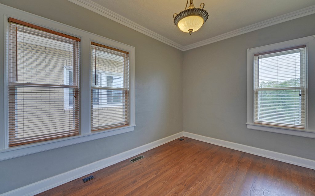 2465 Blue Ridge Drive Blue Ridge, GA 30513 - Photo 36 of 60 an empty room with wooden floor a chandelier fan and windows