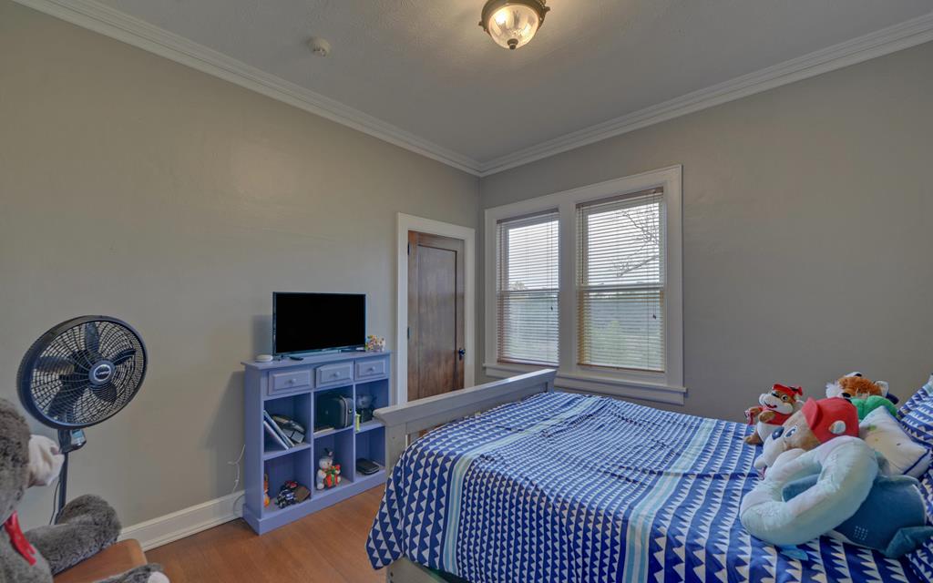 2465 Blue Ridge Drive Blue Ridge, GA 30513 - Photo 43 of 60 a bedroom with a bed and a flat tv screen on dresser