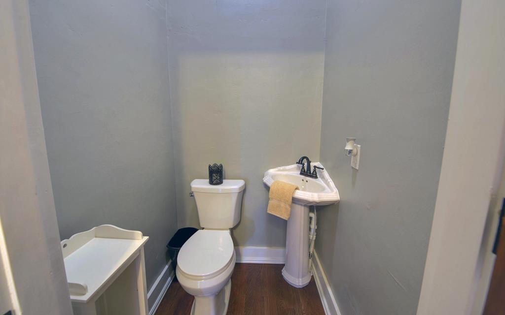 2465 Blue Ridge Drive Blue Ridge, GA 30513 - Photo 46 of 60 a white toilet sitting next to a bathroom sink