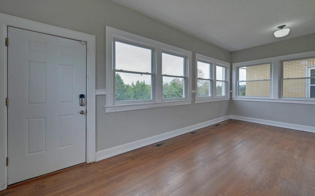 2465 Blue Ridge Drive Blue Ridge, GA 30513 - Photo 49 of 60 an empty room with wooden floor and windows