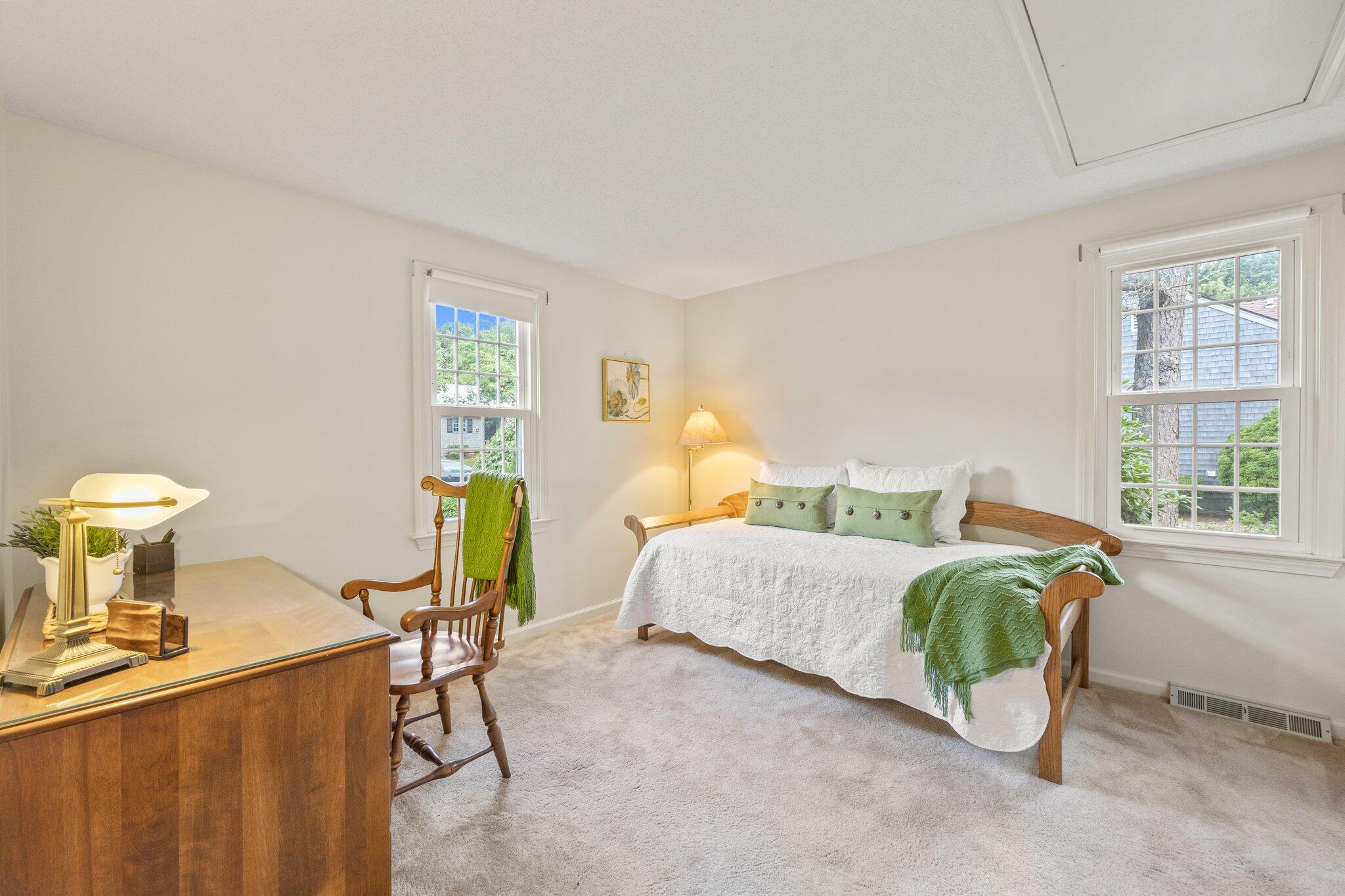 22 Debs Hill Road, Unit 6A Yarmouth Port, MA 02675 - Photo 19 of 30 a bedroom with a bed and a table
