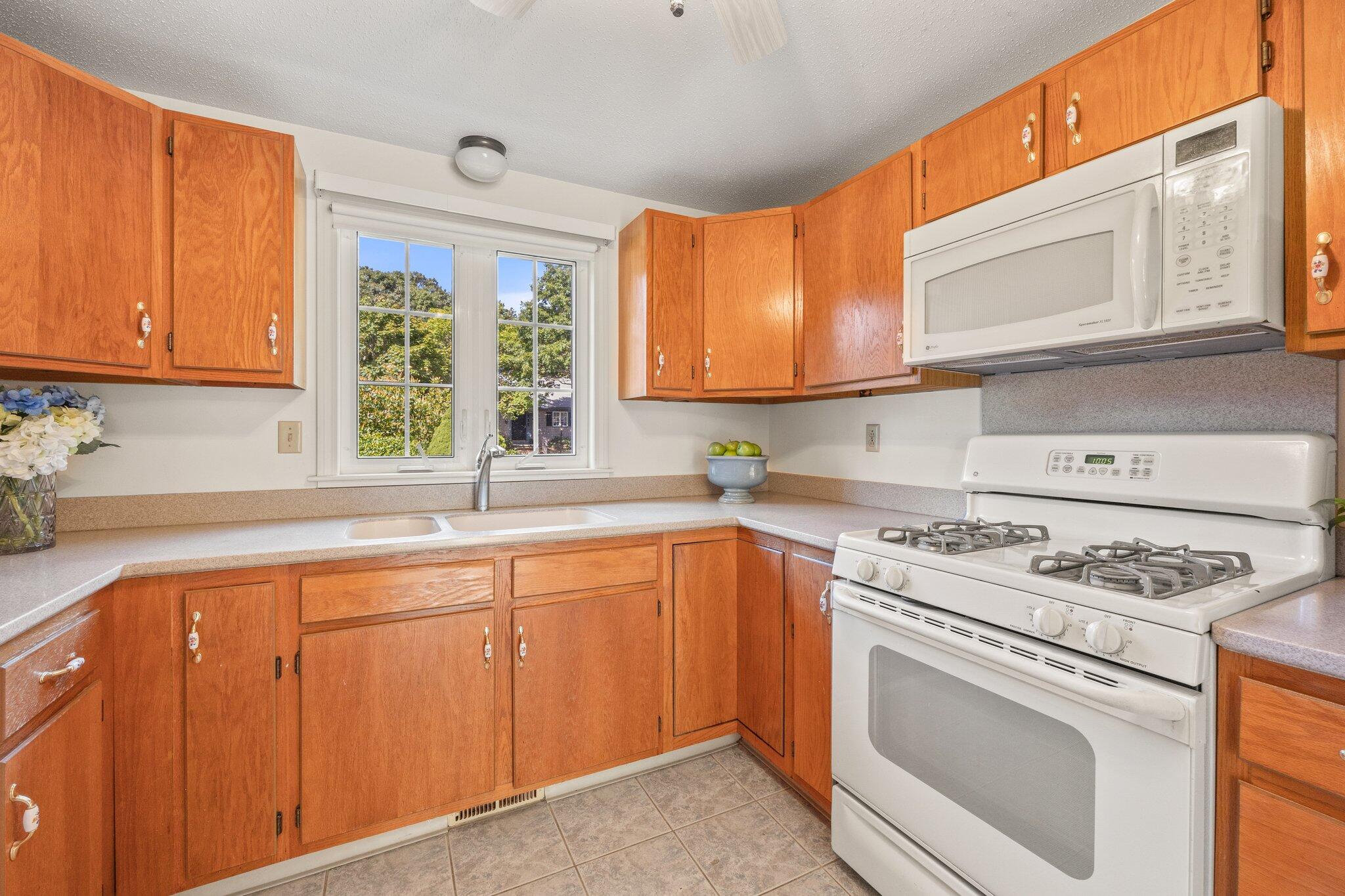 22 Debs Hill Road, Unit 6A Yarmouth Port, MA 02675 - Photo 7 of 30 a kitchen with a stove a sink and a microwave