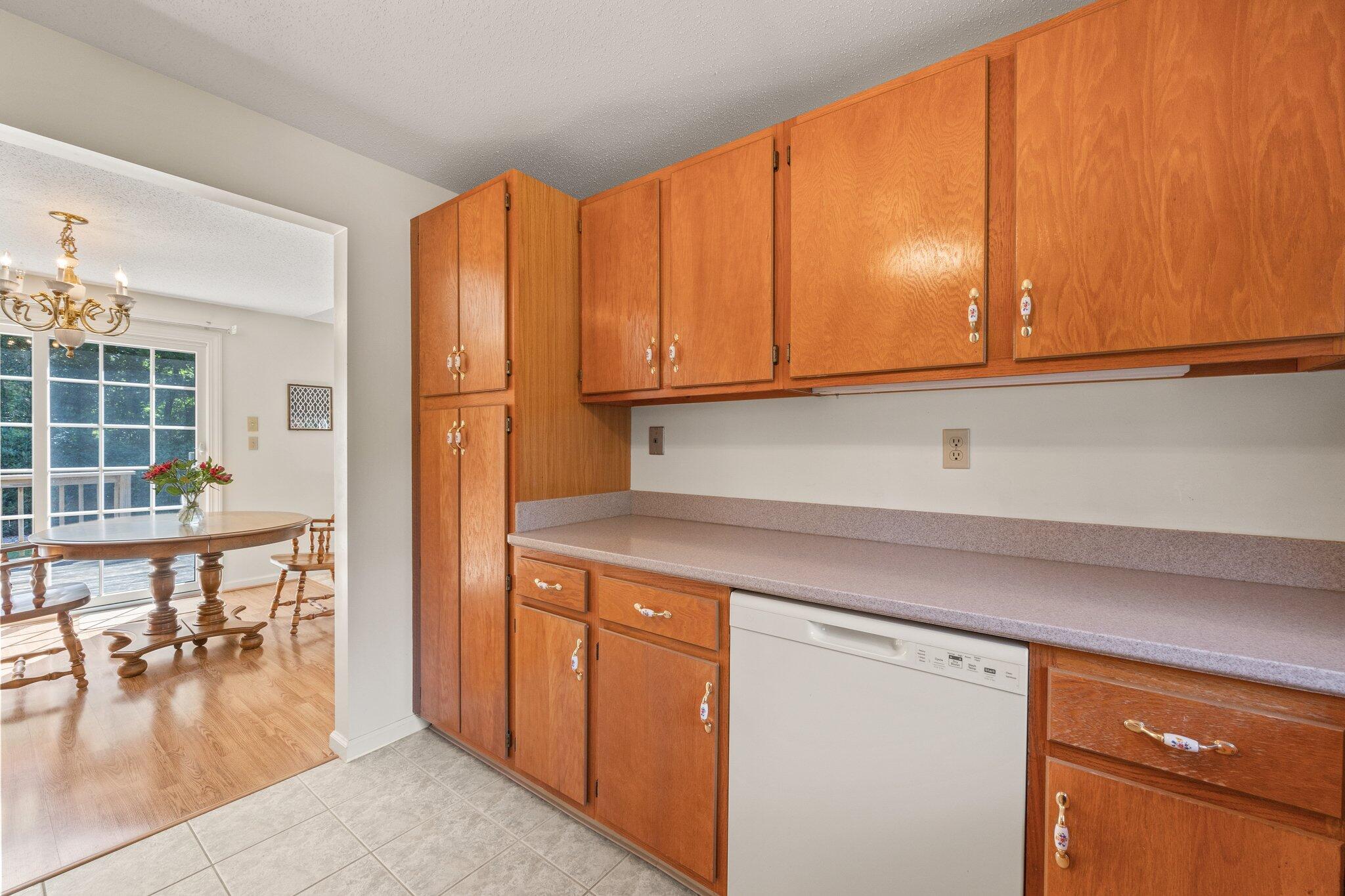 22 Debs Hill Road, Unit 6A Yarmouth Port, MA 02675 - Photo 8 of 30 a kitchen with a wooden cabinets and a dining table chair