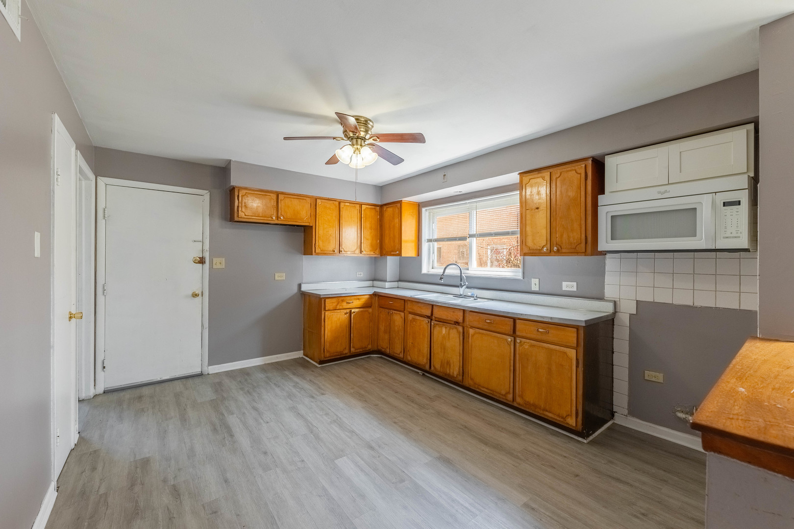 4634 West 47th Street, Unit 1 Chicago, IL 60632 - Photo 16 of 18 a kitchen with stainless steel appliances granite countertop a sink cabinets and wooden floor