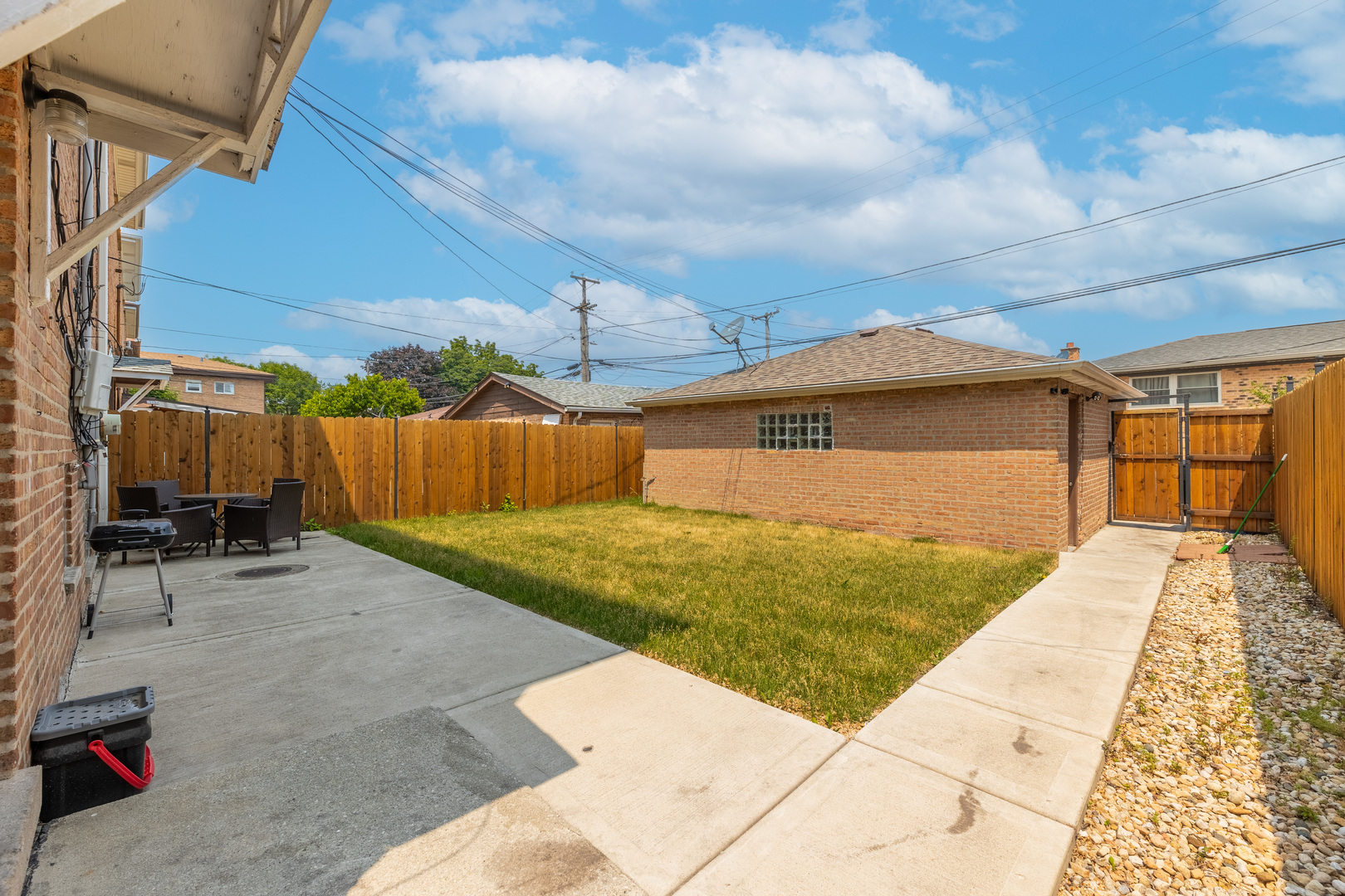 4634 West 47th Street, Unit 1 Chicago, IL 60632 - Photo 18 of 18 a view of backyard with barbeque grill and wooden fence