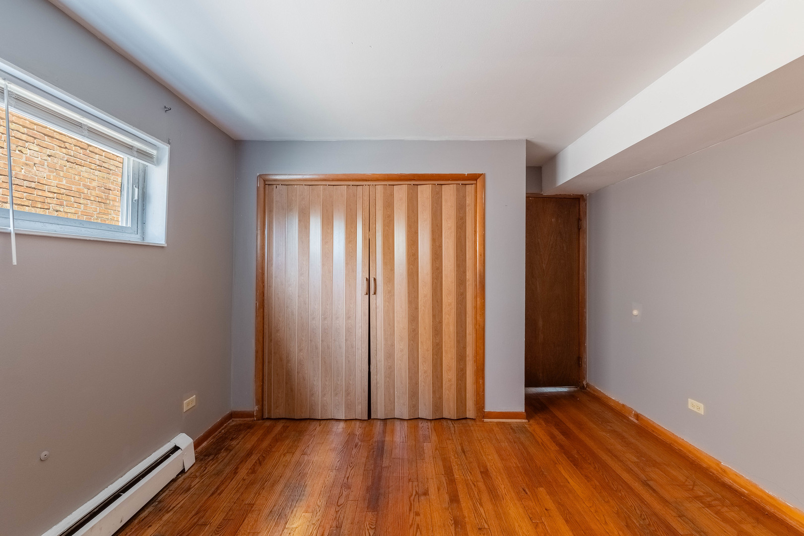 4634 West 47th Street, Unit 1 Chicago, IL 60632 - Photo 7 of 18 an empty room with wooden floor and windows