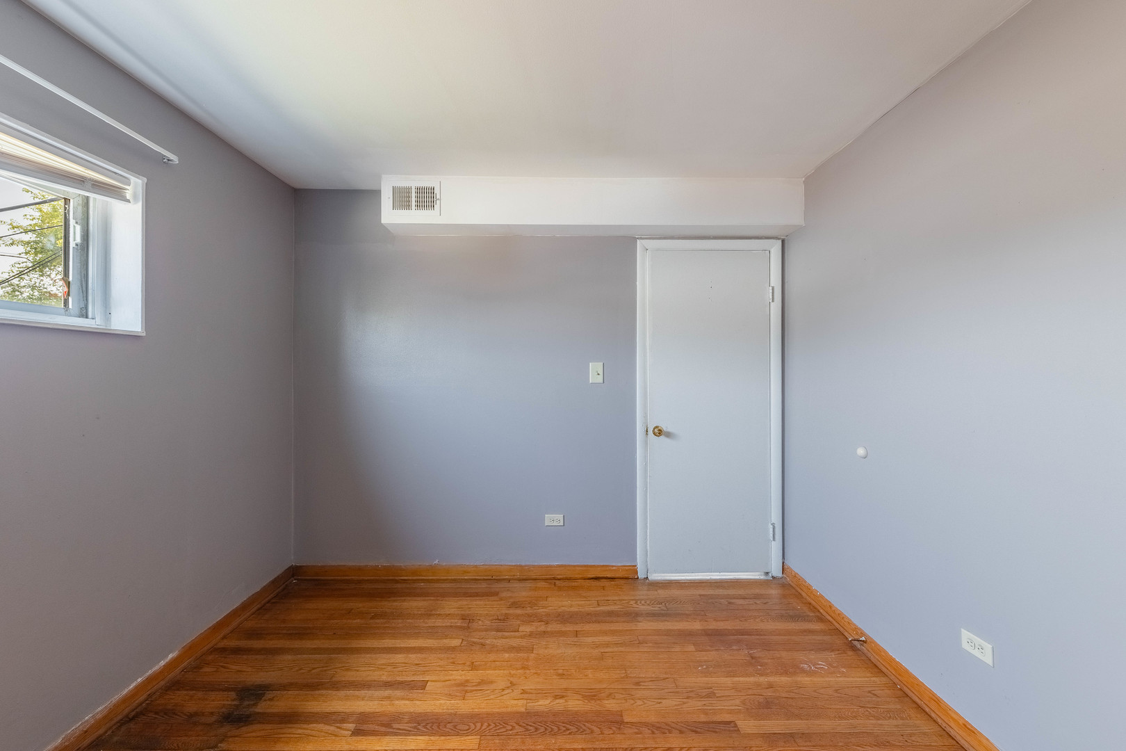 4634 West 47th Street, Unit 1 Chicago, IL 60632 - Photo 8 of 18 a view of an empty room with wooden floor and a window