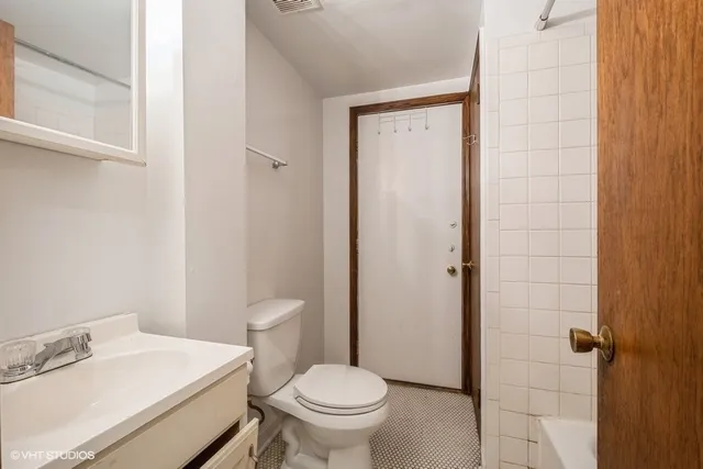 a white toilet sitting next to a bathroom sink