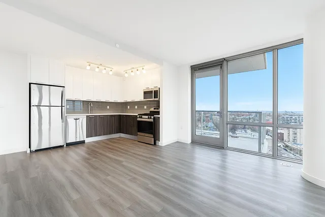 a kitchen with stainless steel appliances a stove top oven a sink and a microwave