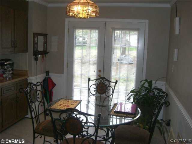 4733 Crossgate Road Chester, VA 23831 - Photo 2 of 9 a view of a dining room with furniture and chandelier