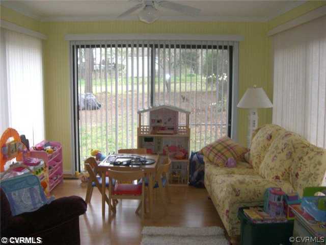 4733 Crossgate Road Chester, VA 23831 - Photo 4 of 9 a living room with furniture and a floor to ceiling window