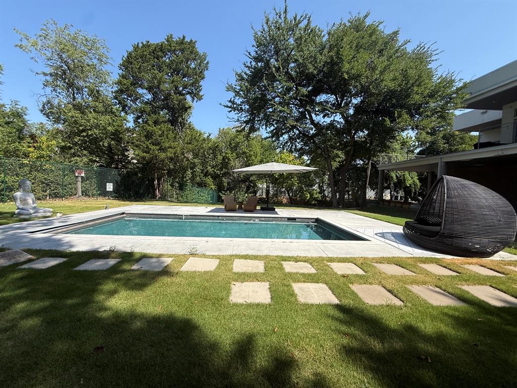 13023 Copenhill Road Dallas, TX 75240 - Photo 28 of 35 Rectangular swimming pool with a stone coping and surrounding concrete patio