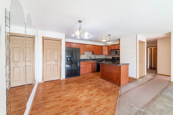 a large kitchen with kitchen island a sink stainless steel appliances and cabinets
