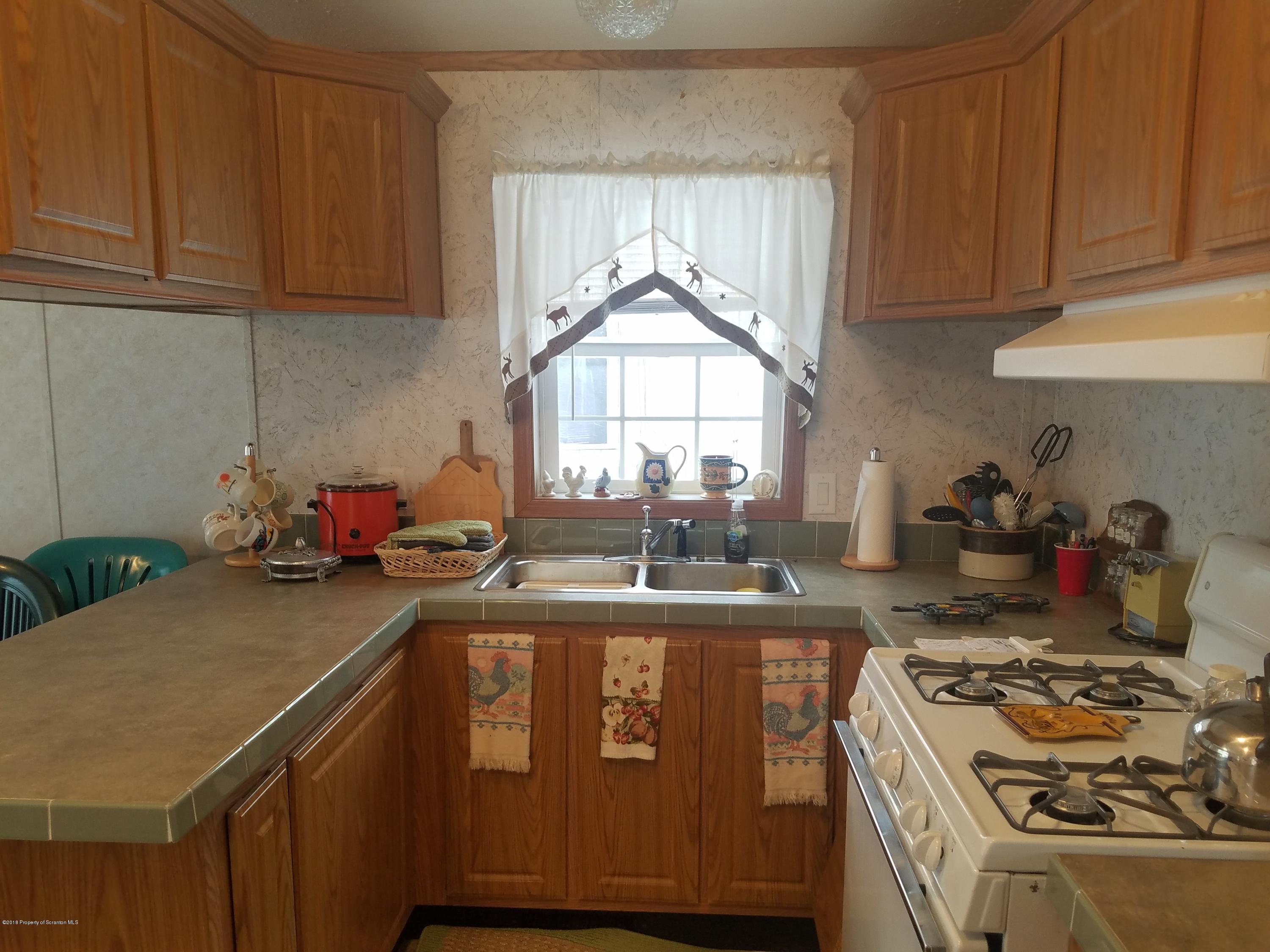 Lakeside Road Hop Bottom, PA 18824 - Photo 2 of 19 a kitchen with a stove a sink and a cabinets