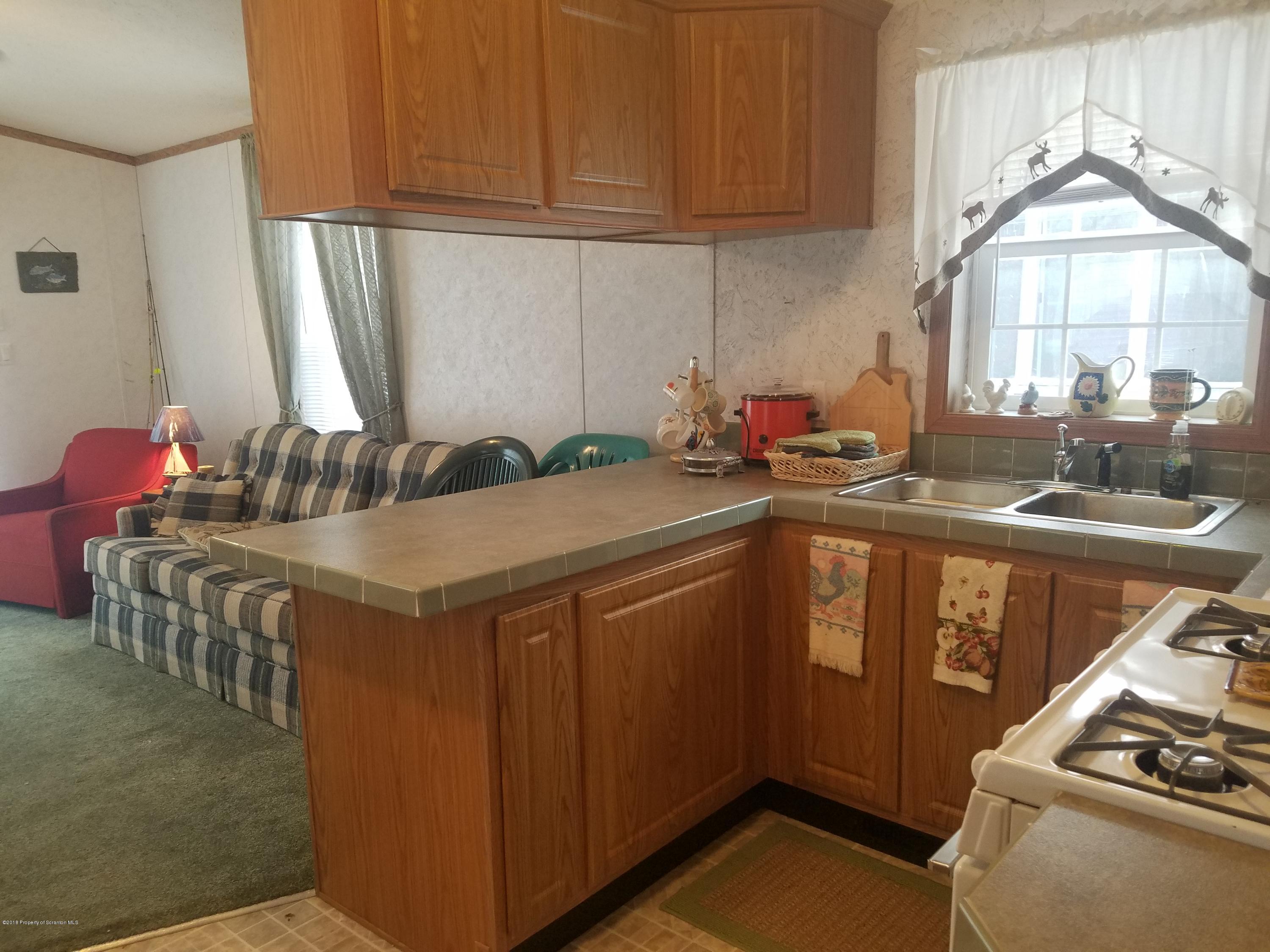 Lakeside Road Hop Bottom, PA 18824 - Photo 6 of 19 a kitchen with a sink stove and cabinets
