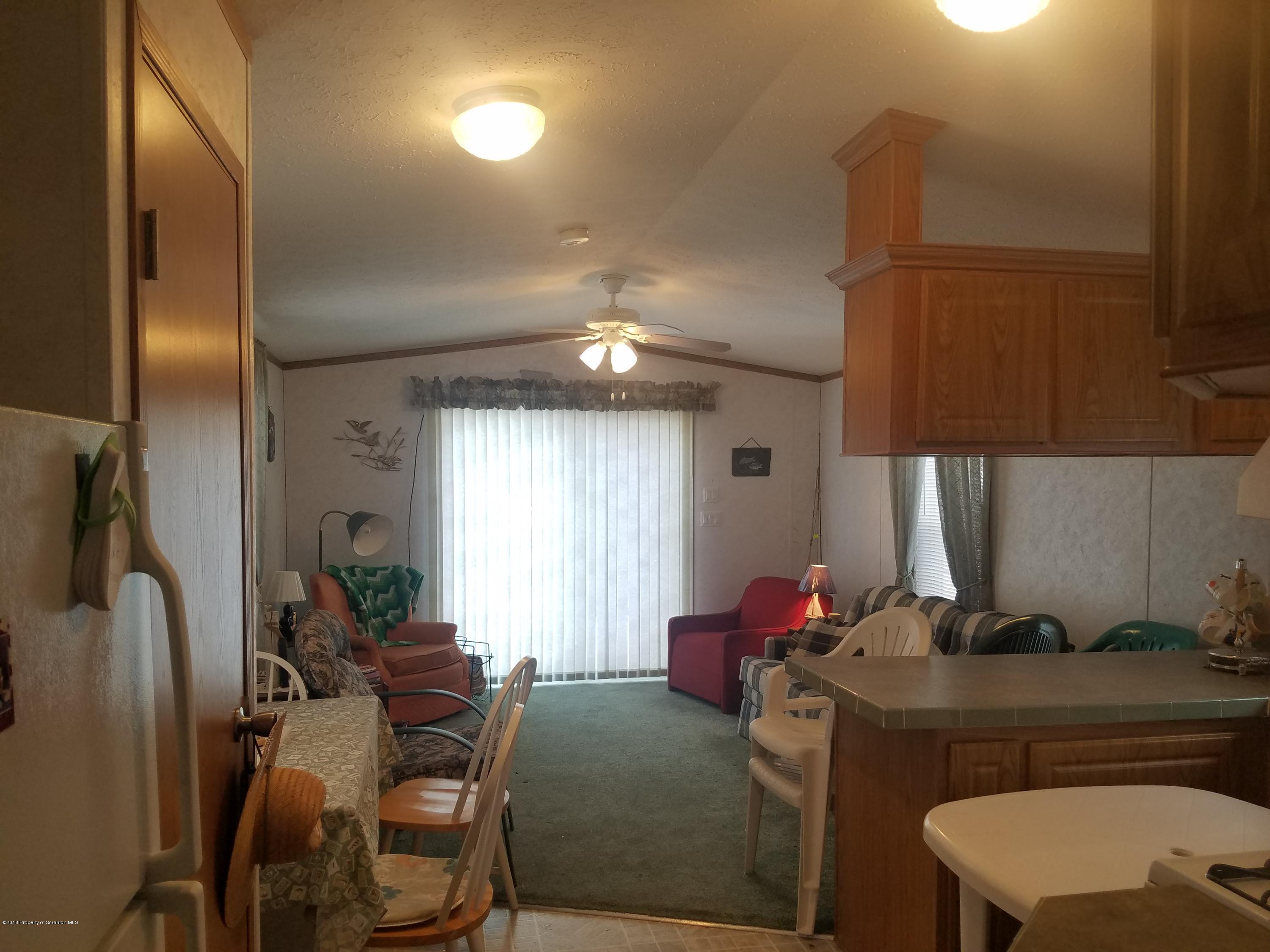 Lakeside Road Hop Bottom, PA 18824 - Photo 8 of 19 a living room with furniture a window and a flat screen tv