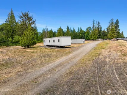 a view of a dry yard with wooden fence