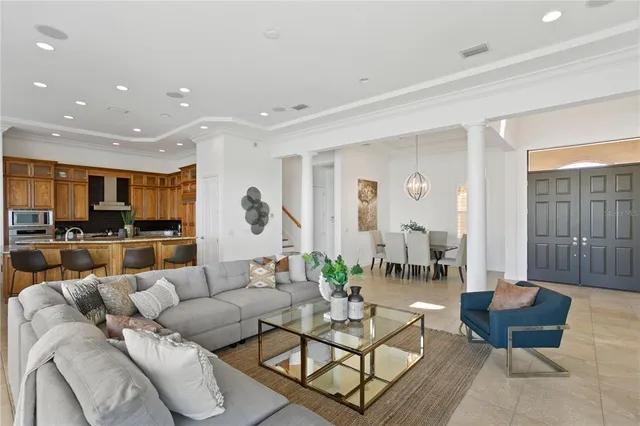 a kitchen with sink refrigerator dining table and chairs