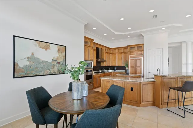 a kitchen with stainless steel appliances granite countertop a stove a sink and a refrigerator