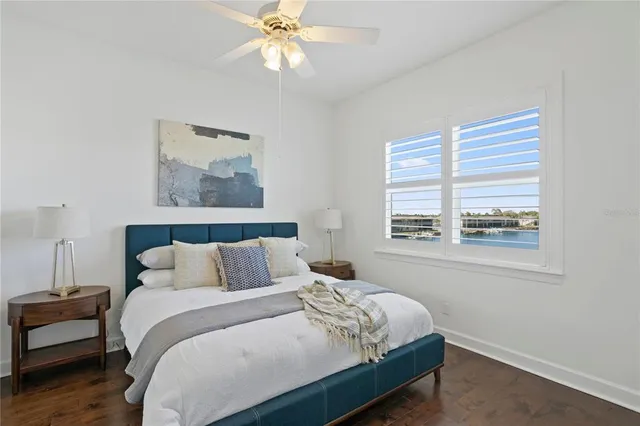 a bedroom with a bed and a painting on the wall