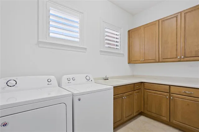 a view of a balcony with two chairs and a potted plant