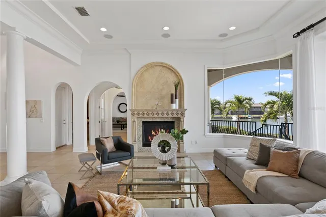 a living room with fireplace furniture and a large window