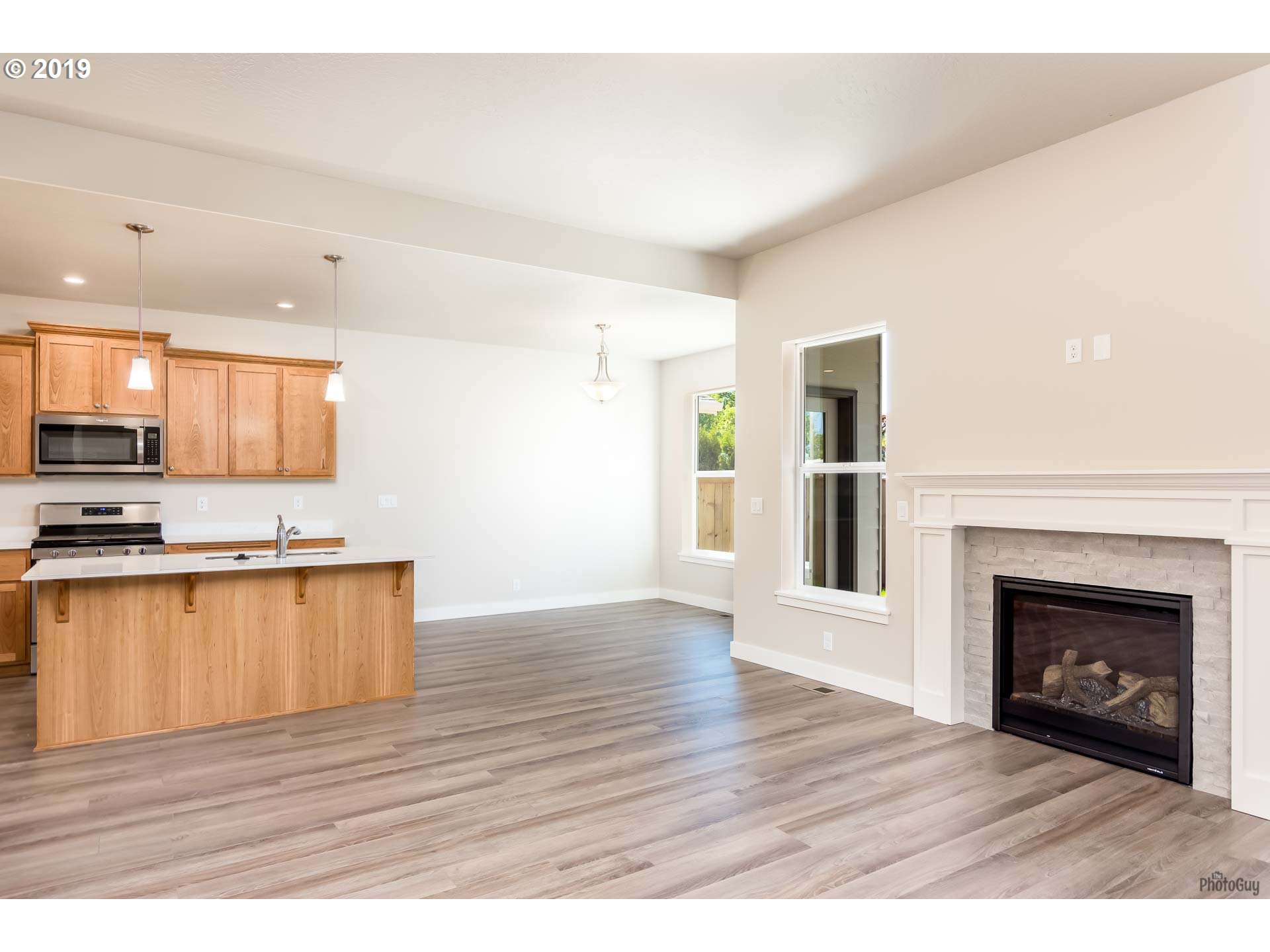 1068 West Olympic Street Springfield, OR 97477 - Photo 11 of 30 a view of a kitchen with a sink a microwave and a refrigerator