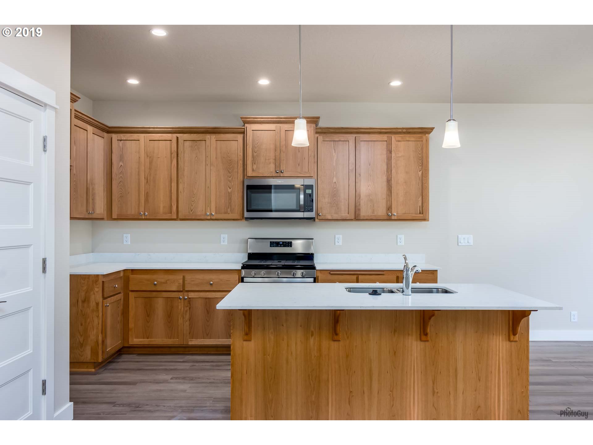1068 West Olympic Street Springfield, OR 97477 - Photo 13 of 30 a kitchen with wooden cabinets and black appliances
