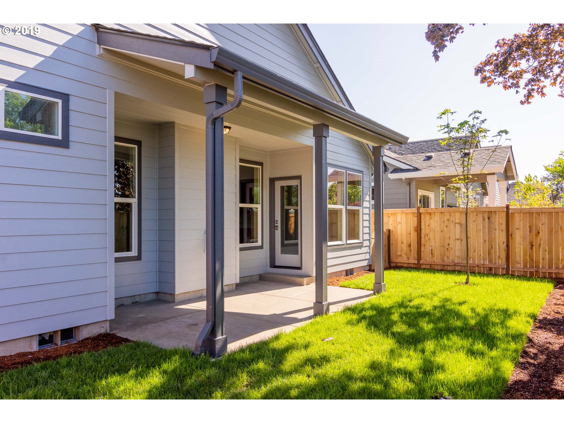 1068 West Olympic Street Springfield, OR 97477 - Photo 14 of 30 a view of a house with a small yard and wooden fence