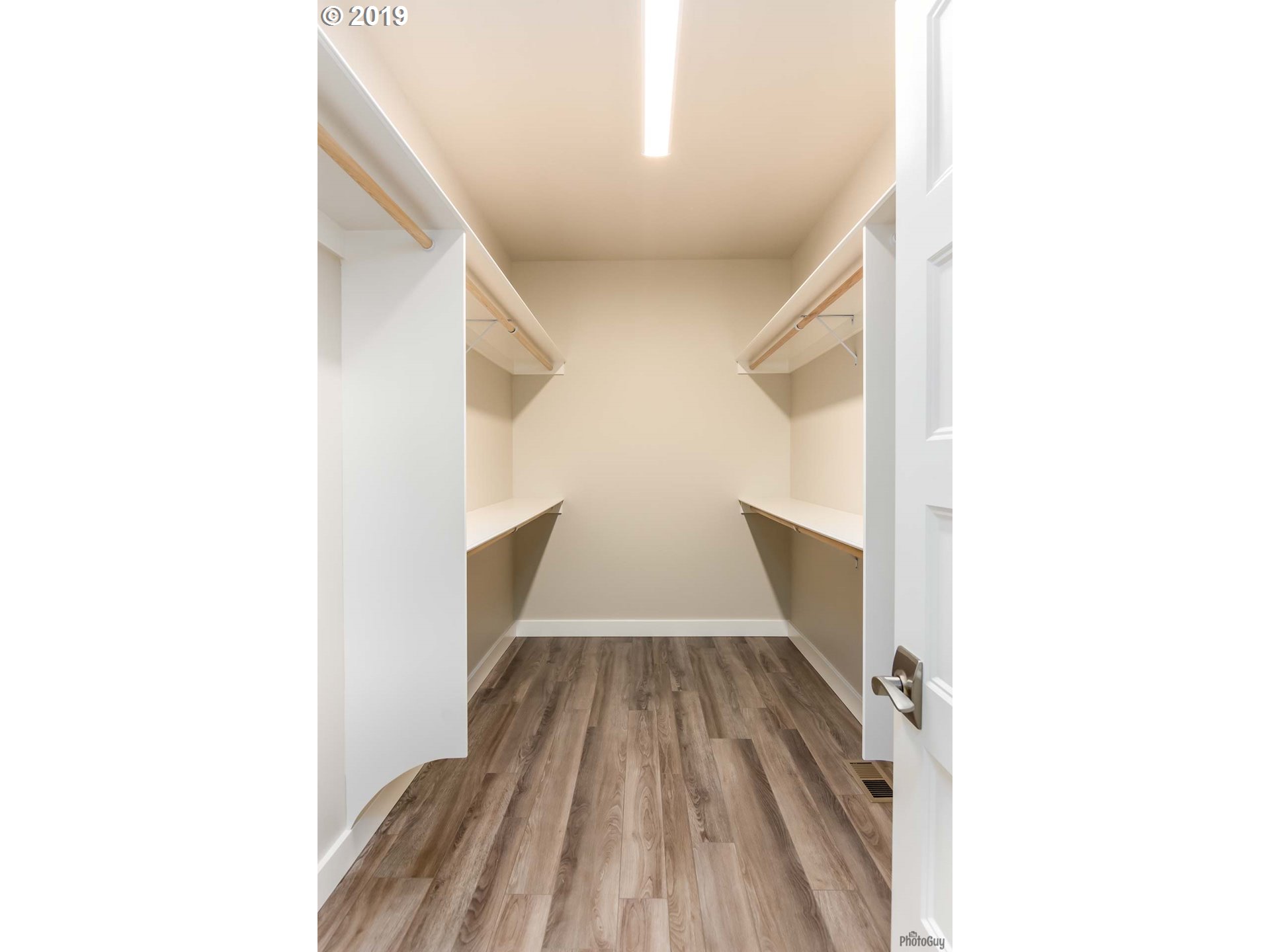 1068 West Olympic Street Springfield, OR 97477 - Photo 25 of 30 a view of a hallway with wooden floor