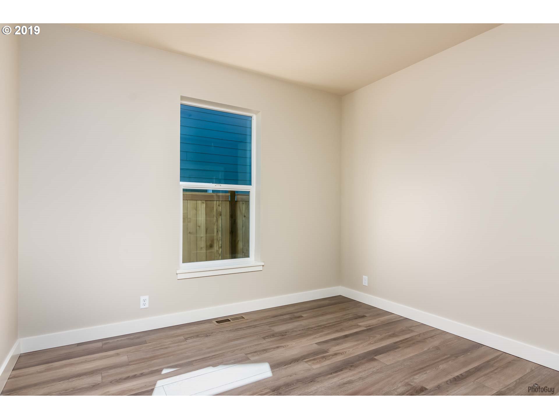 1068 West Olympic Street Springfield, OR 97477 - Photo 27 of 30 an empty room with wooden floor and windows