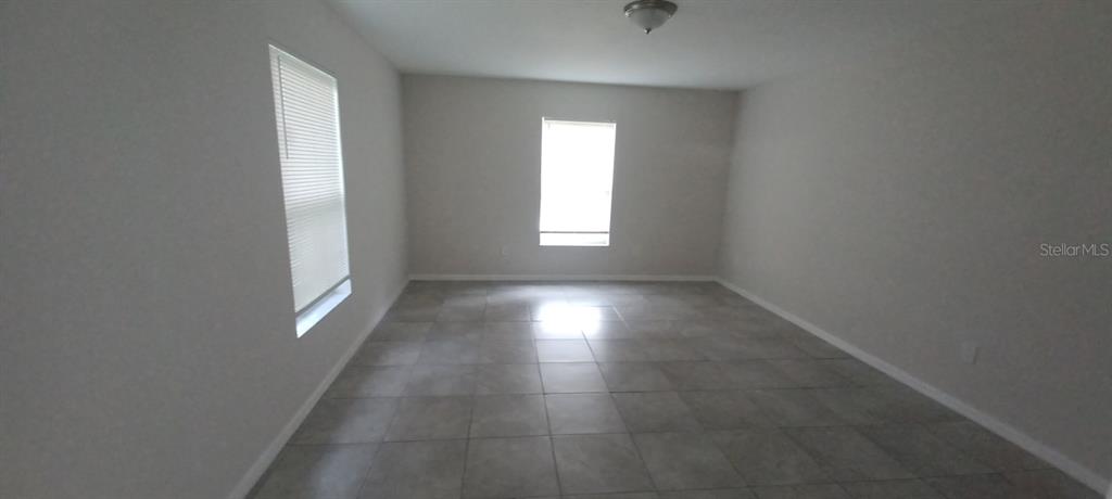 8799 Southwest 66th Avenue Ocala, FL 34476 - Photo 13 of 28 an empty room with windows and entrance
