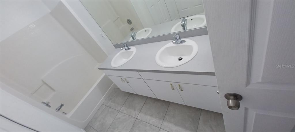 8799 Southwest 66th Avenue Ocala, FL 34476 - Photo 16 of 28 a bathroom with a sink and mirror