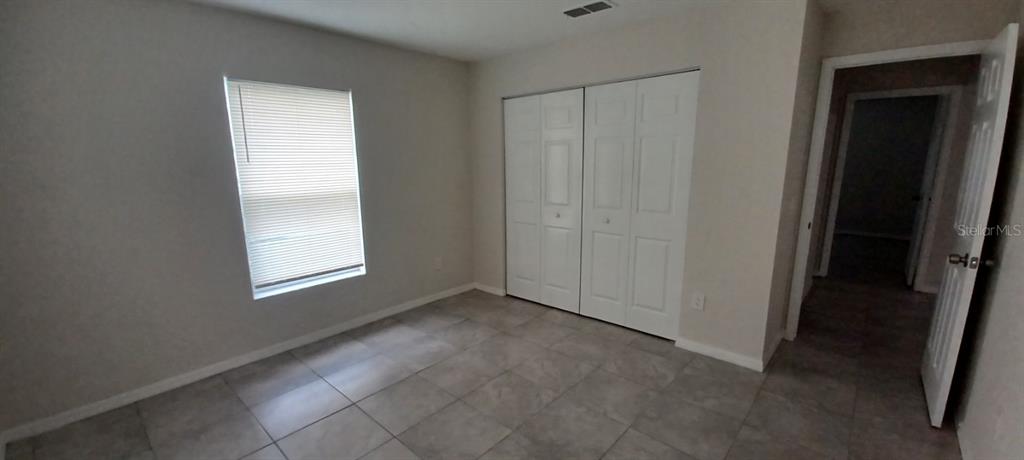 8799 Southwest 66th Avenue Ocala, FL 34476 - Photo 18 of 28 an empty room with windows