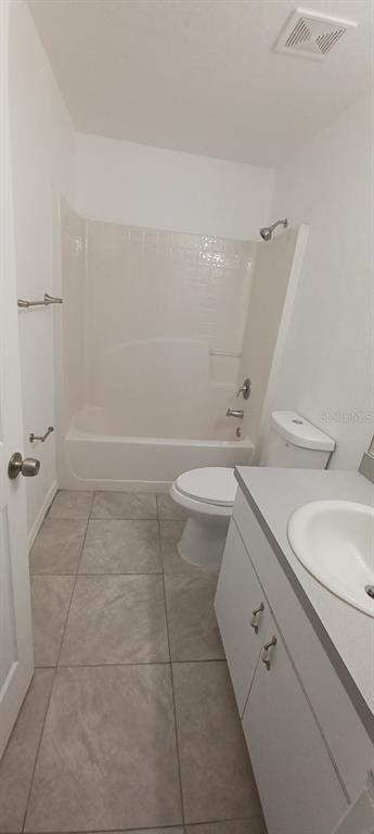 8799 Southwest 66th Avenue Ocala, FL 34476 - Photo 23 of 28 a bathroom with a granite countertop sink toilet a mirror and shower
