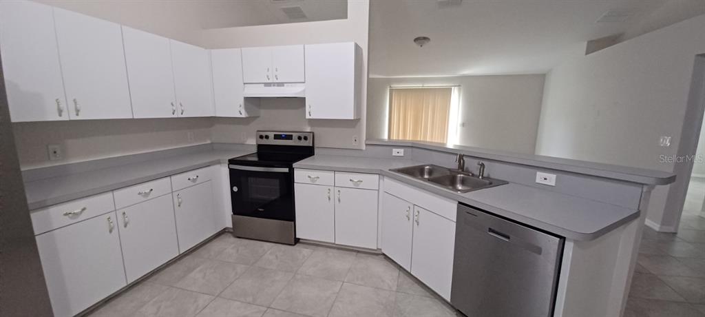 8799 Southwest 66th Avenue Ocala, FL 34476 - Photo 4 of 28 a kitchen with a sink stove and cabinets