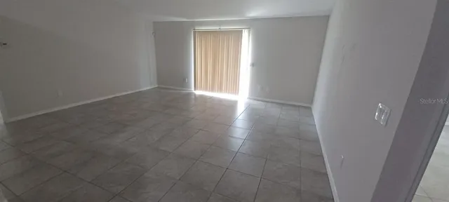 an empty room with a bathroom and a mirror