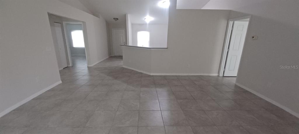 8799 Southwest 66th Avenue Ocala, FL 34476 - Photo 6 of 28 an empty room with a bathroom and a mirror